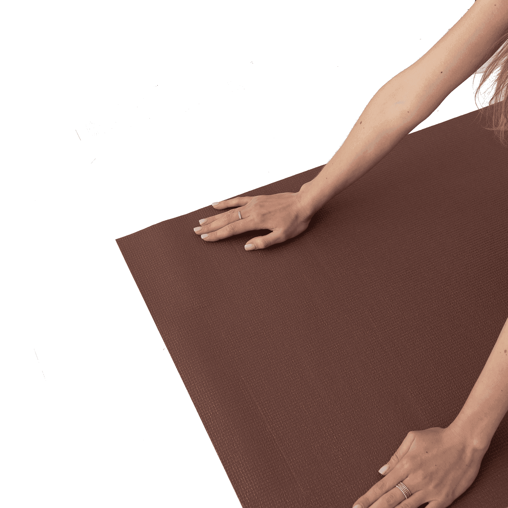 a woman stretches her hands on a yoga mat