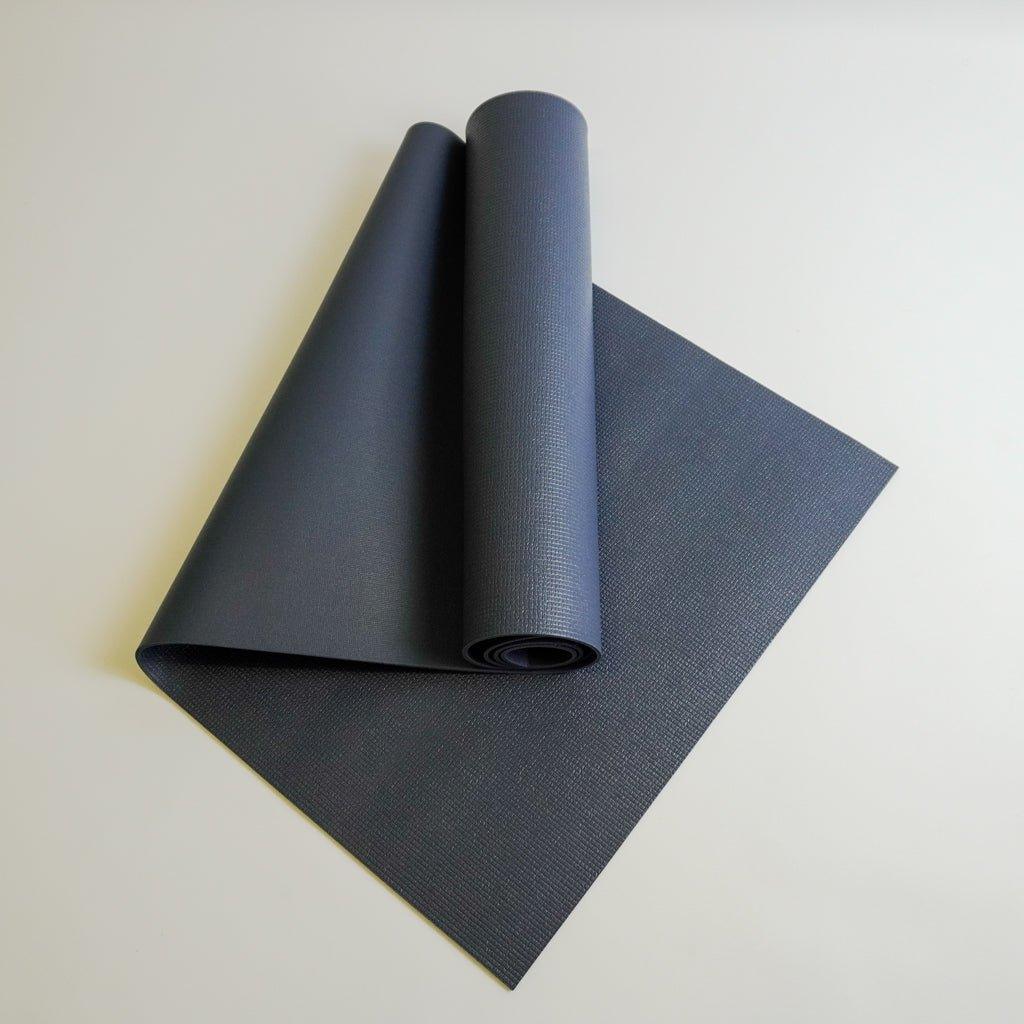 a yoga mat rolled up on top of each other