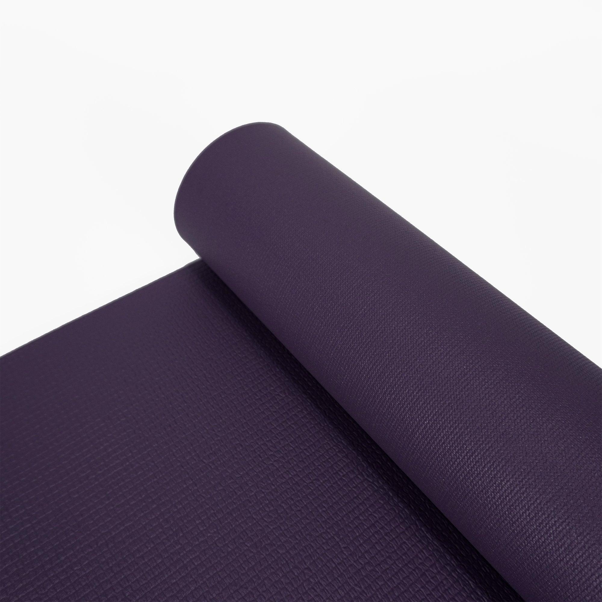 a purple yoga mat on a white background