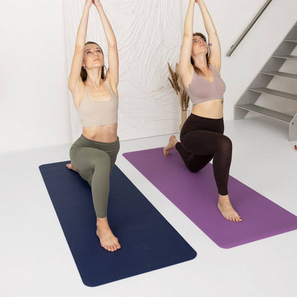 two women doing yoga poses in front of a staircase