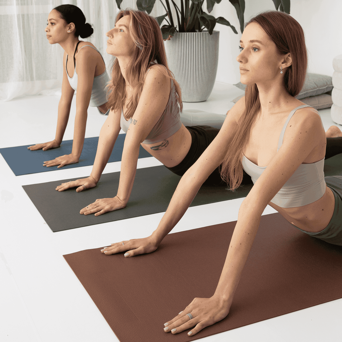 a group of women doing yoga poses in a room